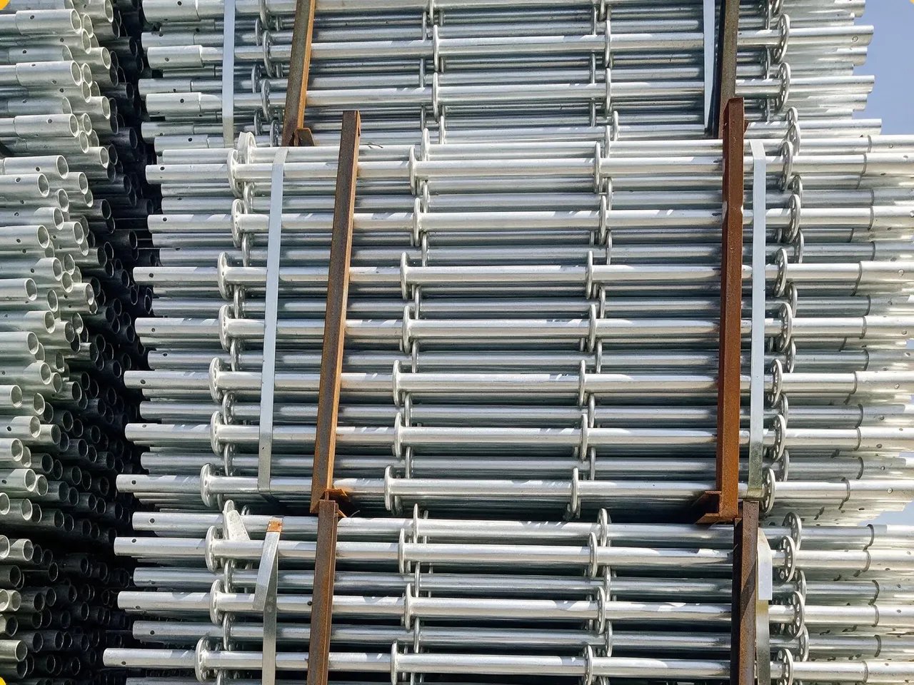 Ringlock scaffolding standards bundled in steel stillages, ready for container loading