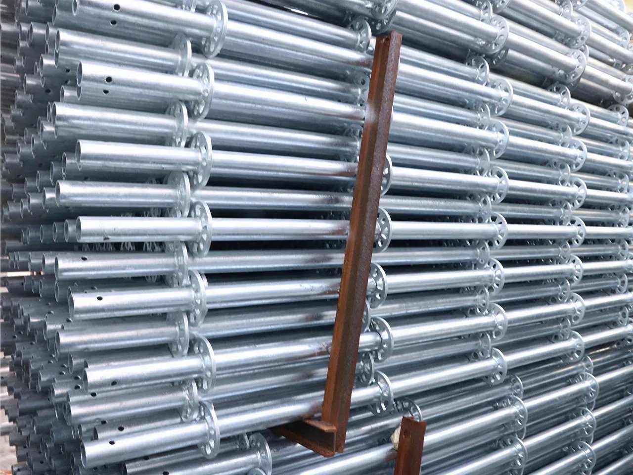 Hot-dip galvanized Ringlock scaffolding standards stacked in steel stillages at the factory
