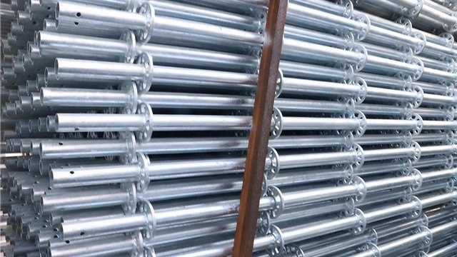 Hot-dip galvanized Ringlock scaffolding standards stacked in steel stillages at the factory